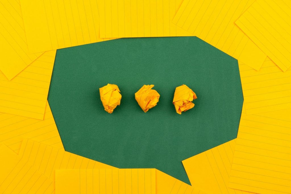 Green and yellow paper forming a speech bubble